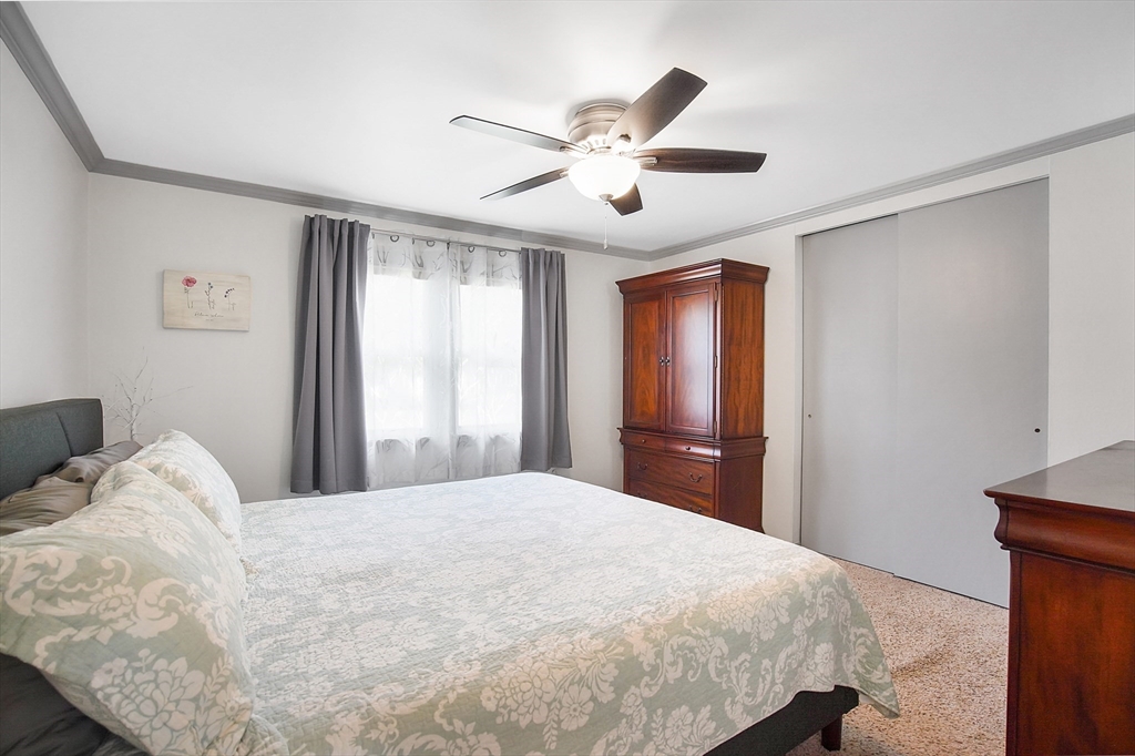 407 Wolf Swamp Road Longmeadow, MA 01106 - Photo 19 of 42 a bedroom with a large bed and a large window