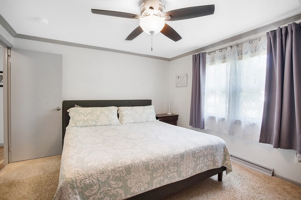 407 Wolf Swamp Road Longmeadow, MA 01106 - Photo 20 of 42 a bedroom with a large bed and a large window