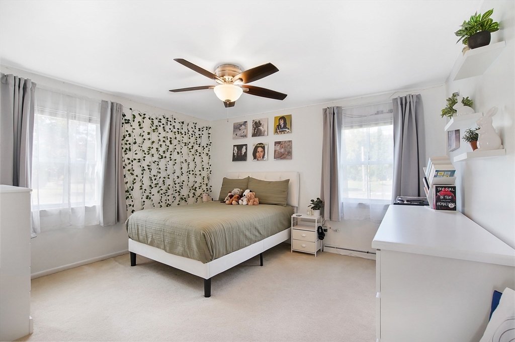 407 Wolf Swamp Road Longmeadow, MA 01106 - Photo 21 of 42 a bedroom with a bed and a large window with the outer view