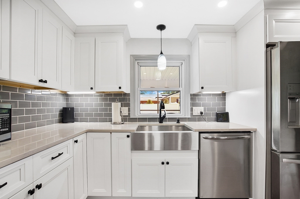 407 Wolf Swamp Road Longmeadow, MA 01106 - Photo 4 of 42 a kitchen with stainless steel appliances granite countertop a refrigerator a sink dishwasher a stove and white cabinets with wooden floor