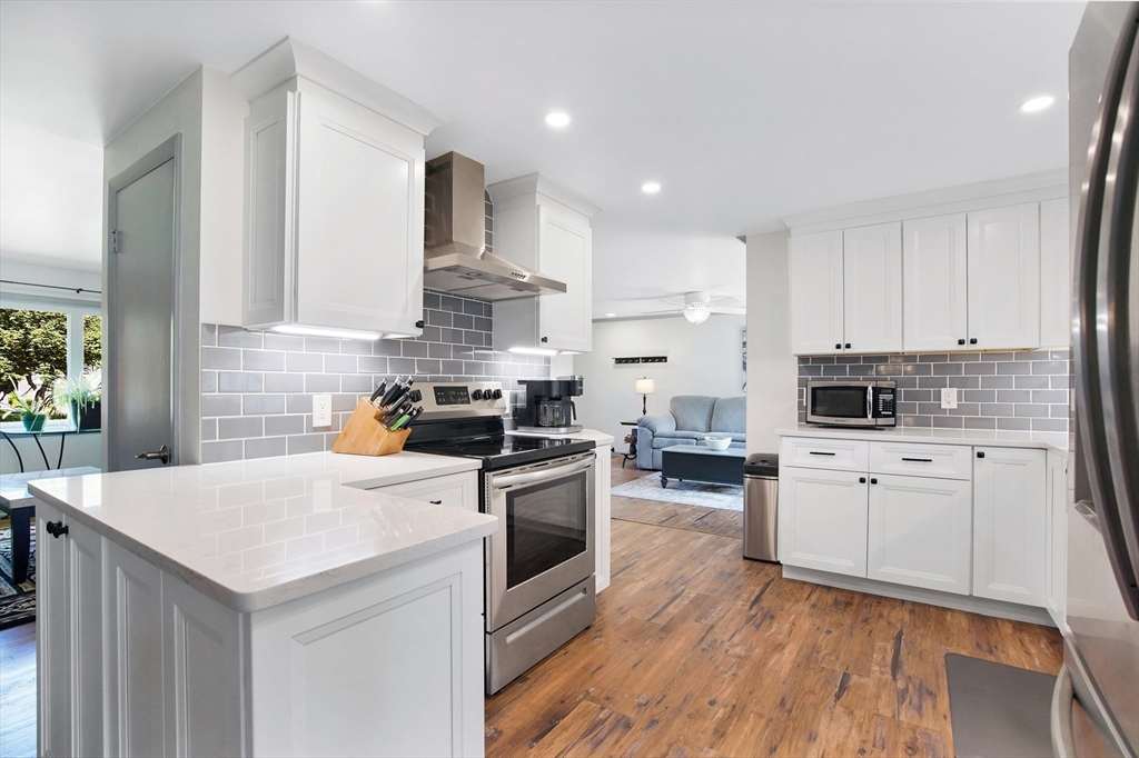 407 Wolf Swamp Road Longmeadow, MA 01106 - Photo 6 of 42 a kitchen with a stove a sink and a refrigerator