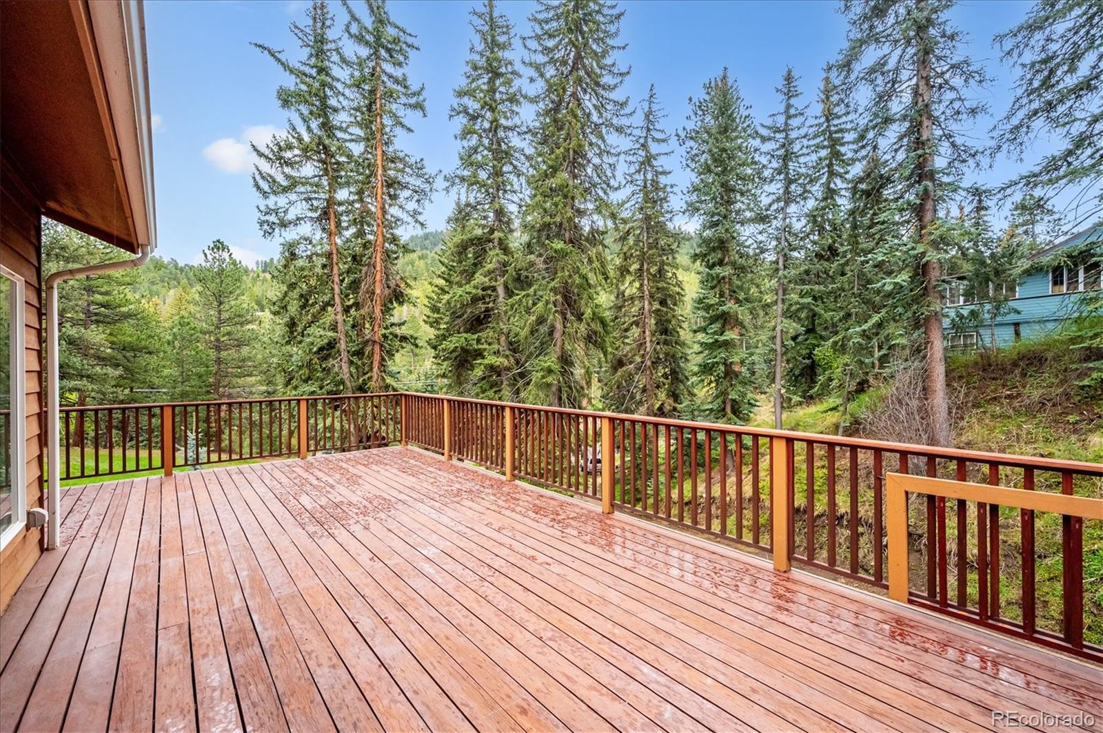 6747 South Brook Forest Road Evergreen, CO 80439 - Photo 3 of 49 a view of balcony with wooden floor and outdoor space