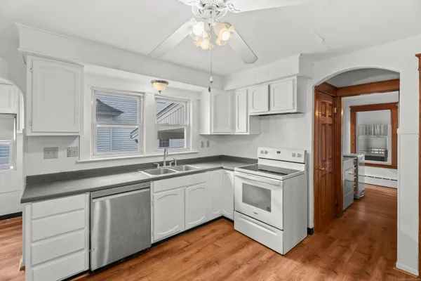 a kitchen with cabinets a sink and appliances