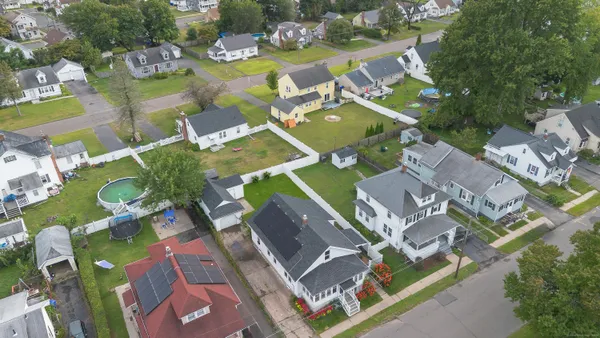 an aerial view of residential house with outdoor space and swimming pool