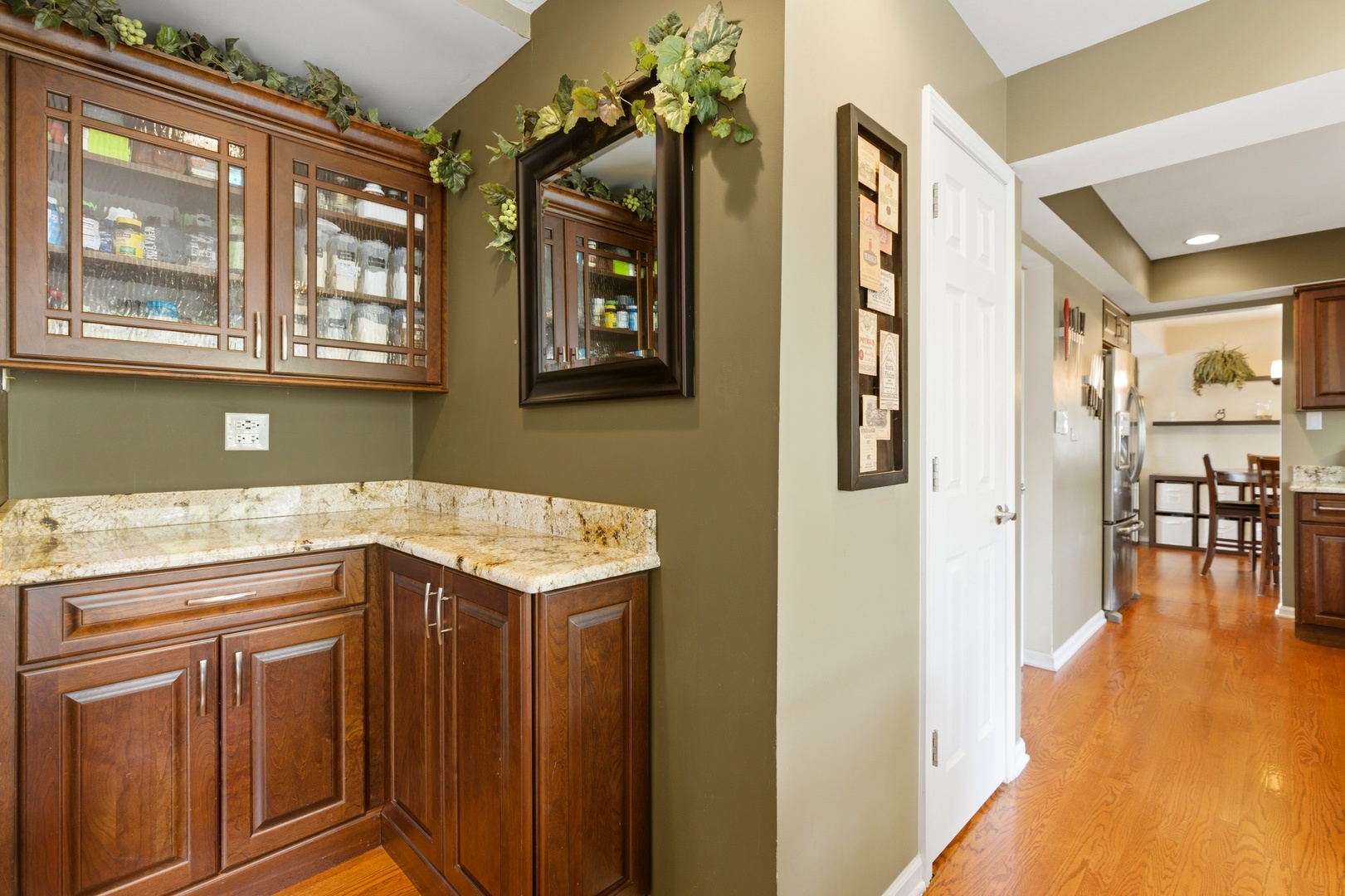 6900 Olde Gatehouse Road Tinley Park, IL 60477 - Photo 18 of 37 a kitchen with stainless steel appliances granite countertop a refrigerator and a view of living room