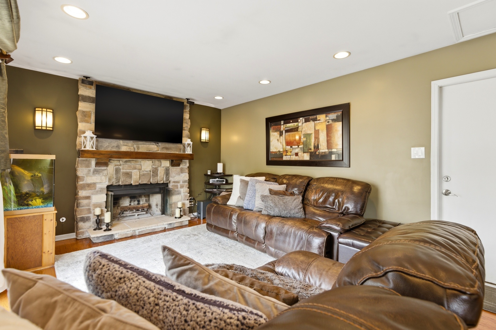 6900 Olde Gatehouse Road Tinley Park, IL 60477 - Photo 20 of 37 a living room with furniture a fireplace and a flat screen tv