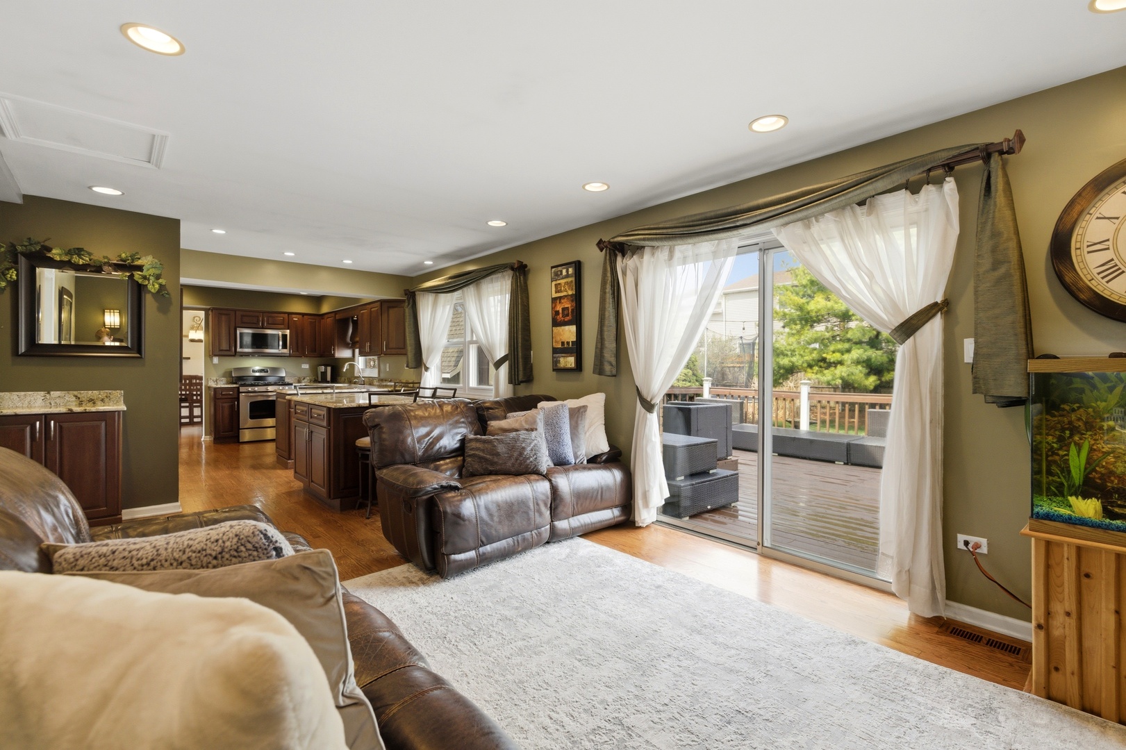 6900 Olde Gatehouse Road Tinley Park, IL 60477 - Photo 22 of 37 a living room with furniture floor to ceiling window and a flat screen tv