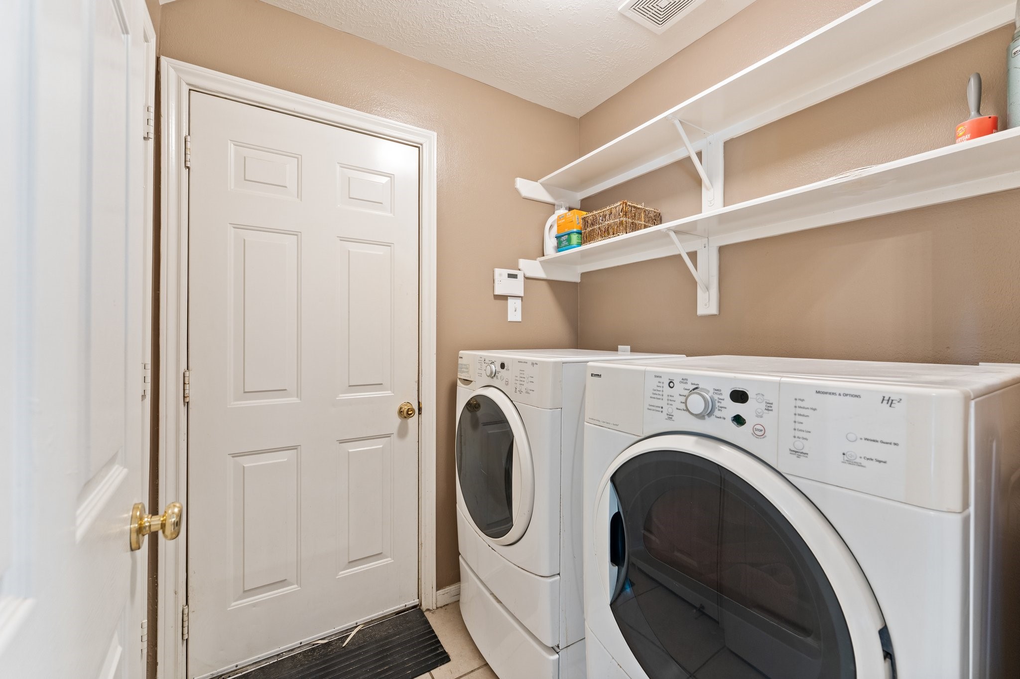 25447 China Springs Spring, TX 77373 - Photo 15 of 45 Laundry room features open shelving and a storage closet to keep you organized.