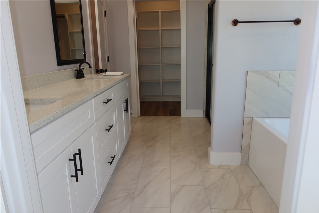 1971 Cambria Drive Bryan, TX 77807 - Photo 13 of 23 a bathroom with a granite countertop sink and a mirror