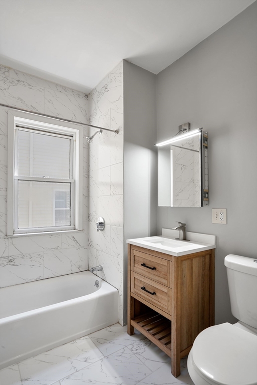 32 Millet Street, Unit 2 Boston, MA 02124 - Photo 13 of 14 a bathroom with a sink a toilet and bathtub