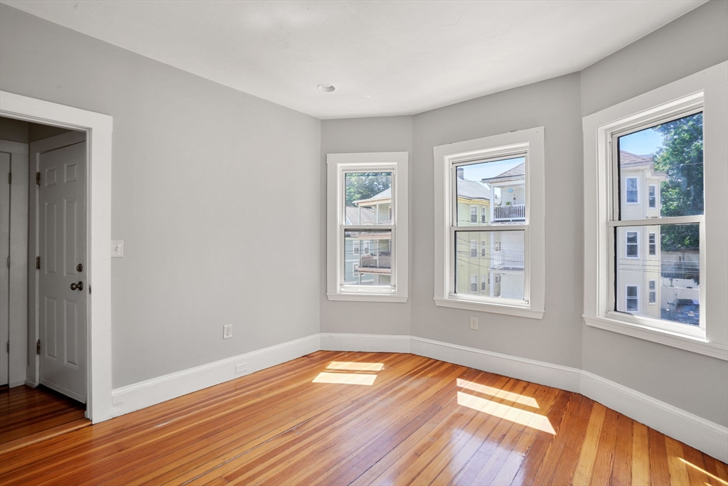32 Millet Street, Unit 2 Boston, MA 02124 - Photo 6 of 14 a view of empty room with wooden floor and fan