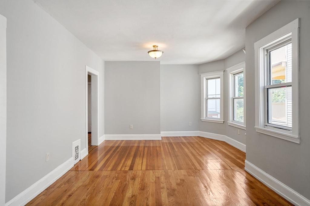 32 Millet Street, Unit 2 Boston, MA 02124 - Photo 8 of 14 wooden floor in an empty room with a window