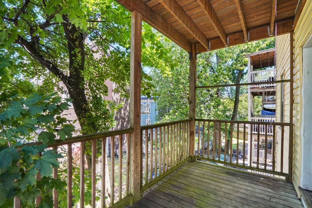 32 Millet Street, Unit 2 Boston, MA 02124 - Photo 10 of 14 a view of a wooden deck next to a yard