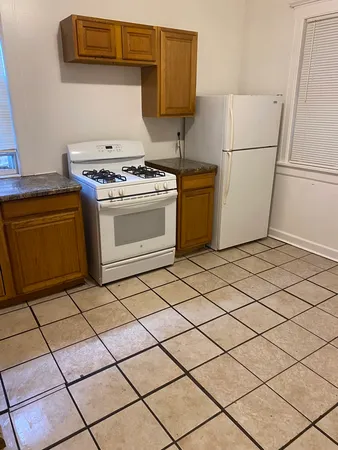 a kitchen with a stove top oven and cabinets