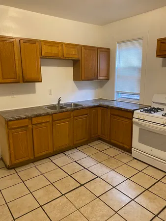 a kitchen with a cabinets sink and white stainless steel appliances