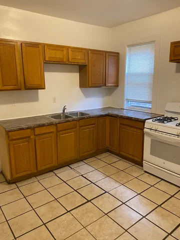 a kitchen with a cabinets sink and white stainless steel appliances