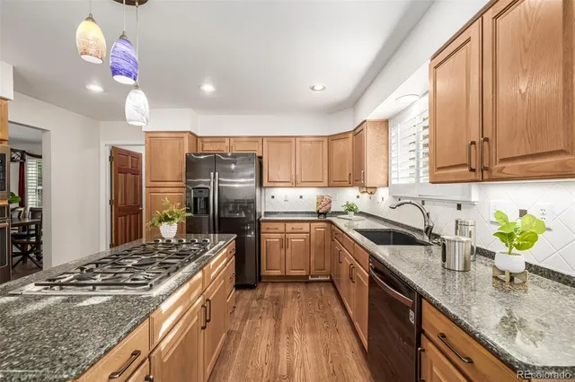 a kitchen with a sink stove and refrigerator