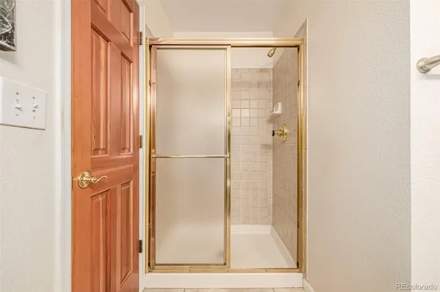 a bathroom with a glass shower door