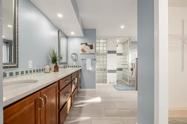 a bathroom with a double vanity sink mirror and