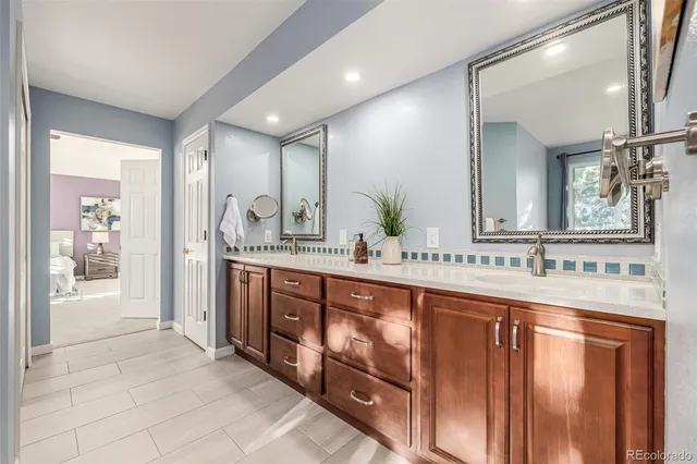 a spacious bathroom with a granite countertop sink mirror and a