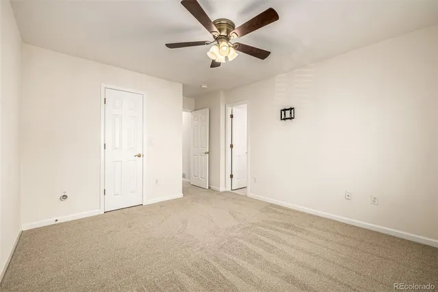 an empty room with fan and a ceiling fan
