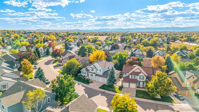 an aerial view of residential houses with outdoor space and swimming pool