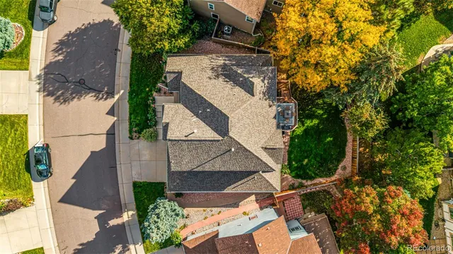 an aerial view of a house with a yard