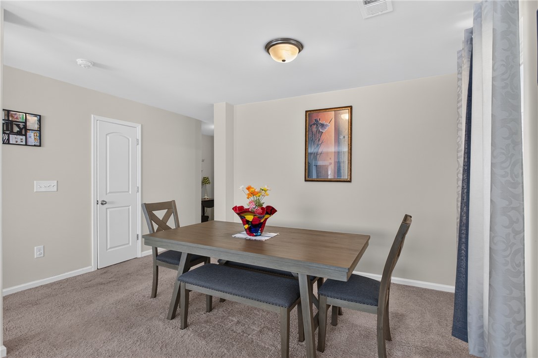 1081 Edenbrooke Circle Anderson, SC 29621 - Photo 17 of 46 A casual dining space features plush carpeting, a modern table, and a ceiling-mounted light fixture.