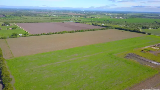 an aerial view of a golf course with a lake view