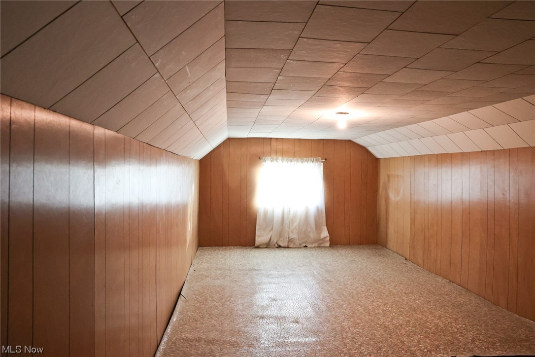 1309 Krumroy Road Akron, OH 44306 - Photo 19 of 30 Additional living space with wooden walls, carpet flooring, and vaulted ceiling