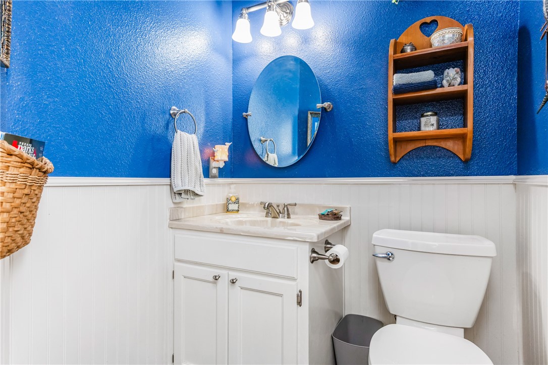 345 Trail Ridge Drive Sandia, TX 78383 - Photo 35 of 40 a bathroom with a toilet a sink and mirror