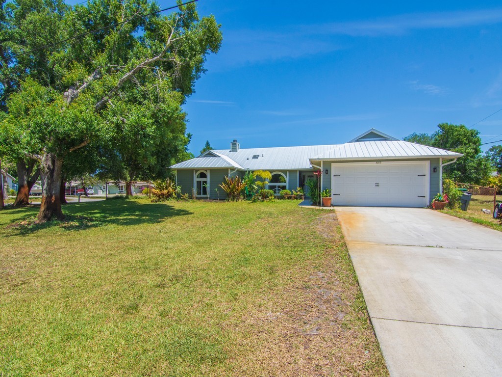 5302 Seminole Road Fort Pierce, FL 34951 - Photo 1 of 36 a front view of a house with a yard