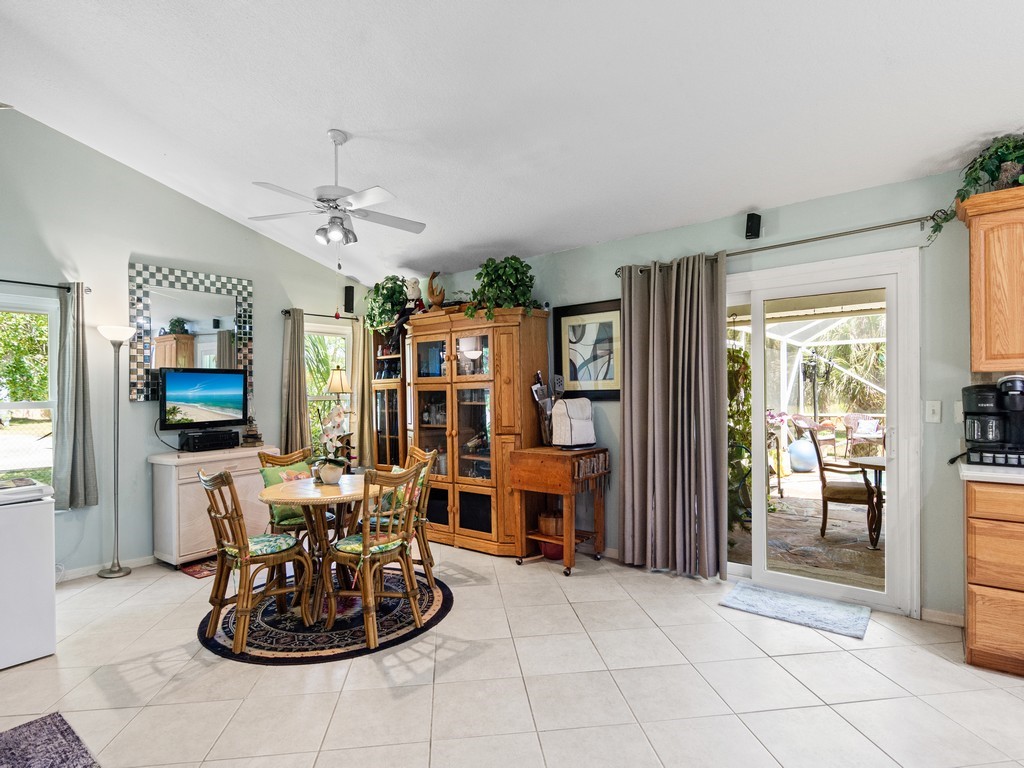 5302 Seminole Road Fort Pierce, FL 34951 - Photo 12 of 36 a living room with furniture a flat screen tv and a large window