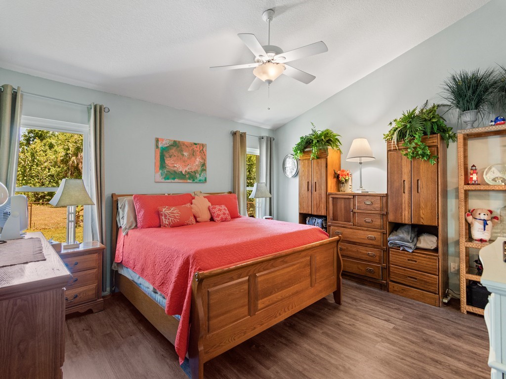 5302 Seminole Road Fort Pierce, FL 34951 - Photo 16 of 36 a bedroom with a bed chandelier and a window