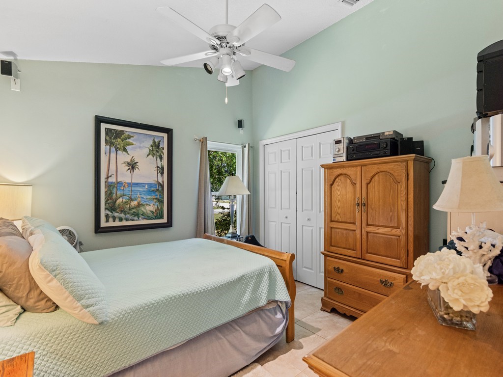 5302 Seminole Road Fort Pierce, FL 34951 - Photo 20 of 36 a bedroom with a bed and a chandelier