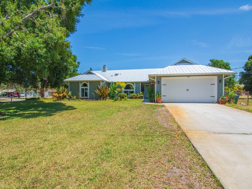 5302 Seminole Road Fort Pierce, FL 34951 - Photo 2 of 36 a view of a white house with a yard