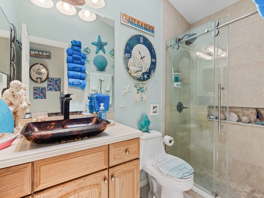 5302 Seminole Road Fort Pierce, FL 34951 - Photo 21 of 36 a bathroom with a toilet sink and shower