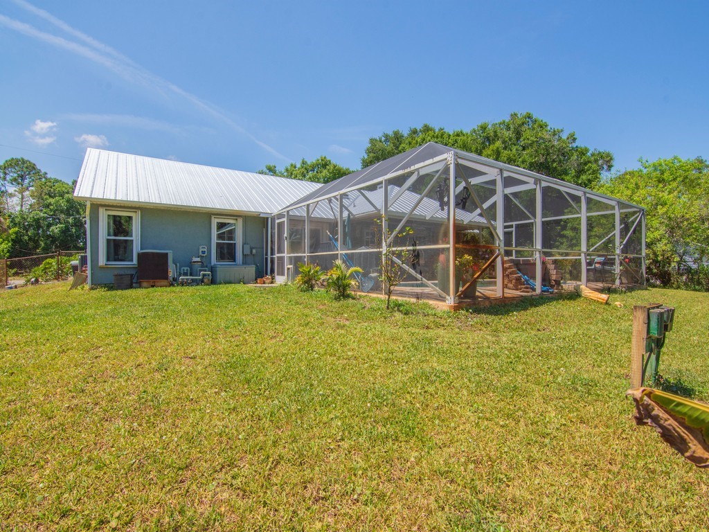 5302 Seminole Road Fort Pierce, FL 34951 - Photo 27 of 36 a view of a house with backyard sitting area and garden