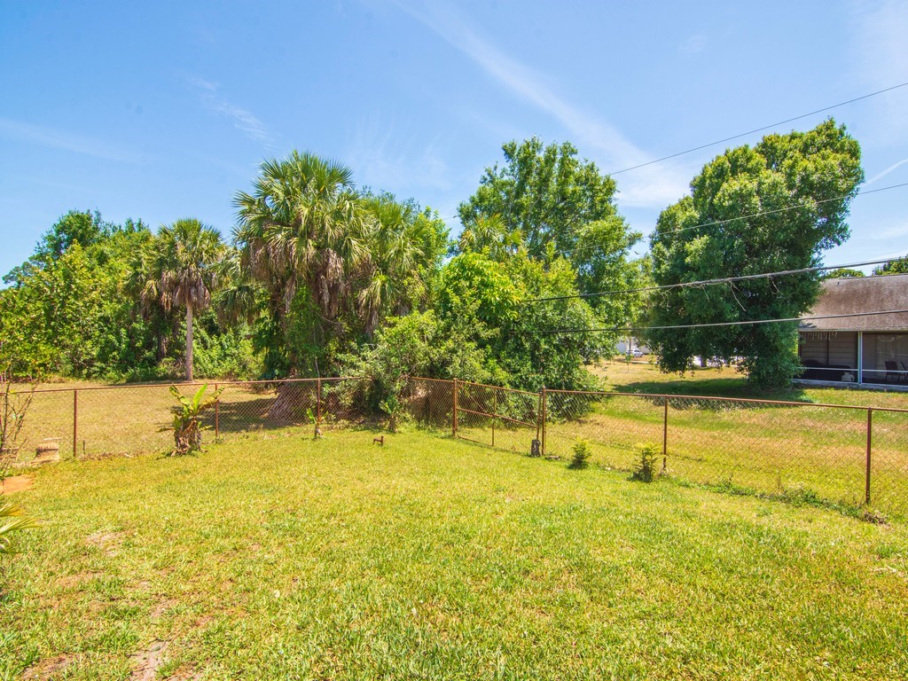 5302 Seminole Road Fort Pierce, FL 34951 - Photo 29 of 36 a view of a swimming pool with an outdoor seating and yard