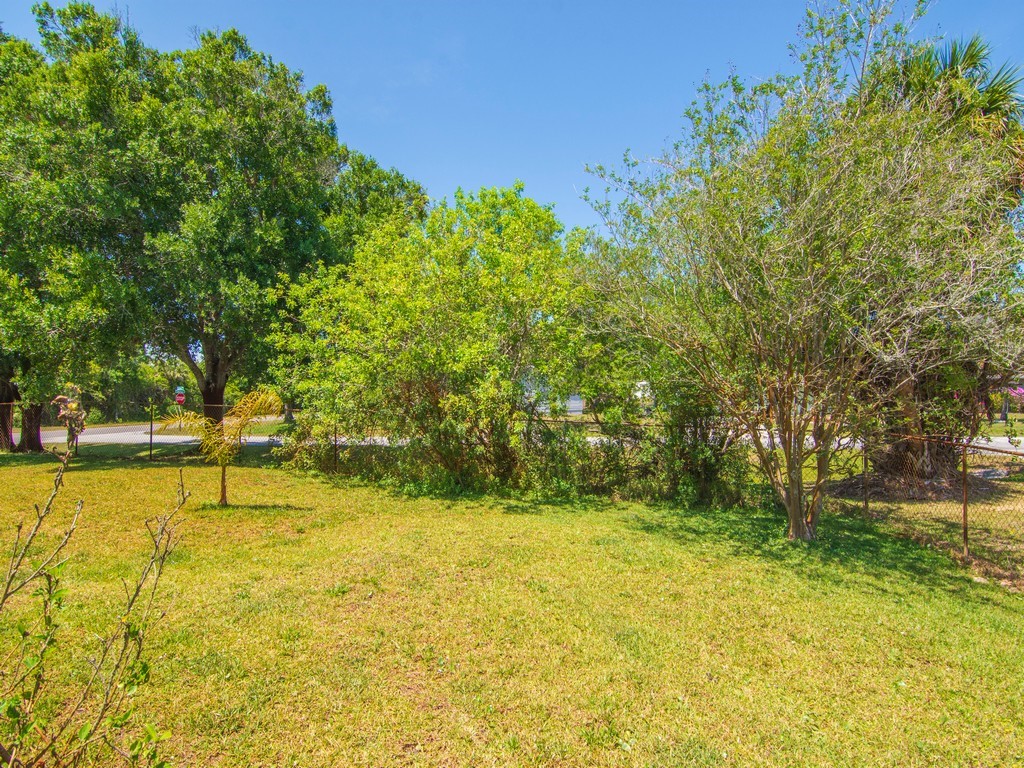 5302 Seminole Road Fort Pierce, FL 34951 - Photo 30 of 36 a view of yard with swimming pool and trees