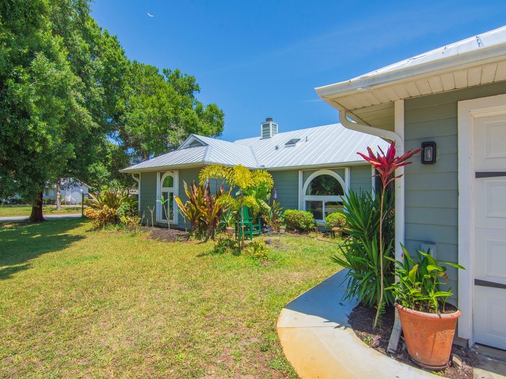 5302 Seminole Road Fort Pierce, FL 34951 - Photo 4 of 36 a front view of house with yard and trees in the background