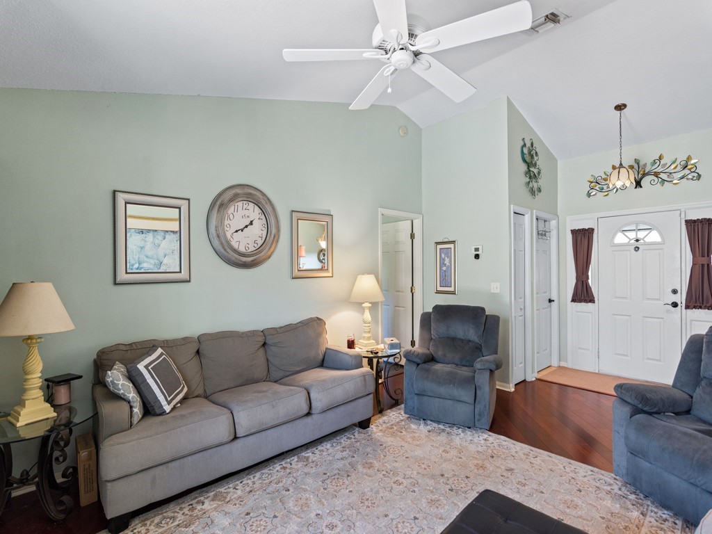 5302 Seminole Road Fort Pierce, FL 34951 - Photo 6 of 36 a living room with furniture a clock on wall and a lamp