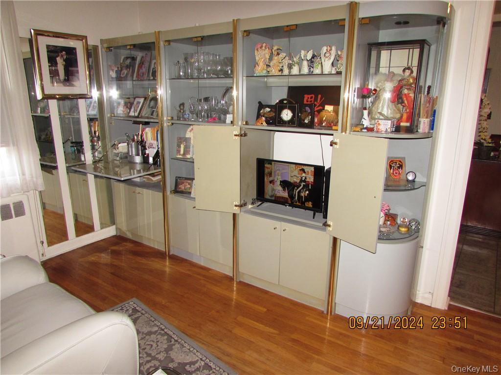 1561 Central Park Avenue, Unit I5 Yonkers, NY 10710 - Photo 14 of 18 Living room featuring radiator, indoor bar, and hardwood / wood-style flooring