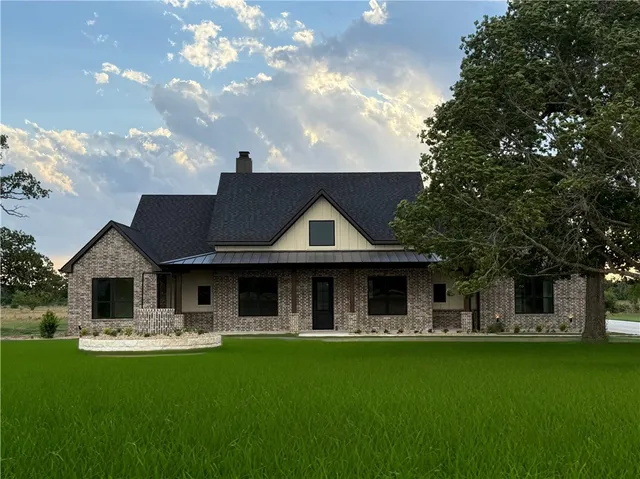 a front view of house with yard barbeque and outdoor seating