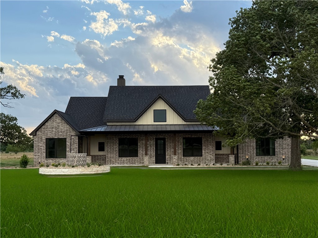 a front view of house with yard barbeque and outdoor seating