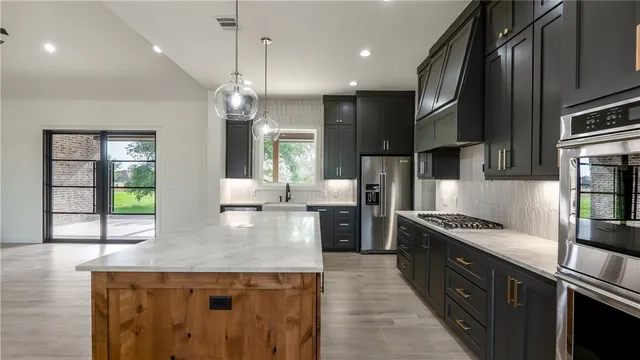 a kitchen with a stove a sink and a refrigerator