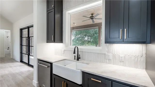 a kitchen with stainless steel appliances granite countertop a refrigerator and a stove