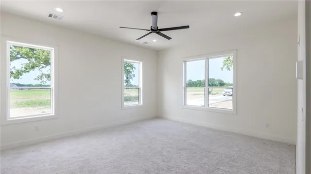 a kitchen with stainless steel appliances granite countertop a refrigerator a sink and a stove