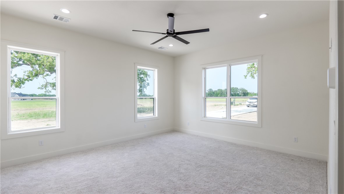 10017 Panther Creek Road Iola, TX 77861 - Photo 18 of 32 an empty room with a window and a ceiling fan