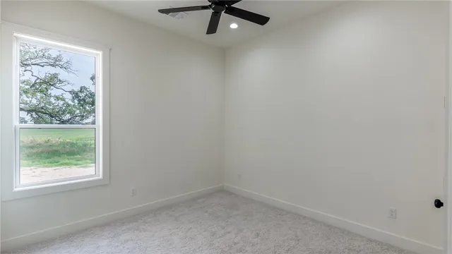 a spacious bathroom with a granite countertop sink and a mirror